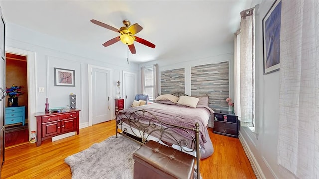 bedroom featuring ceiling fan and light hardwood / wood-style flooring