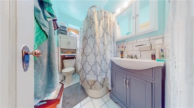 bathroom with tile patterned flooring, vanity, a shower with curtain, and toilet