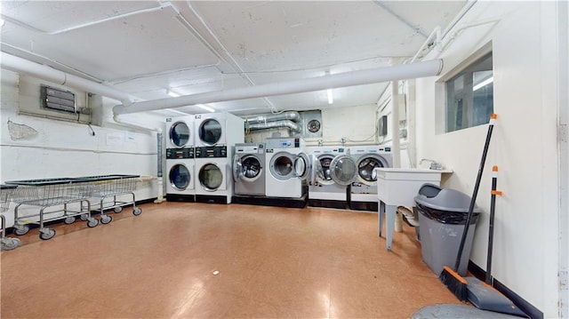 clothes washing area with stacked washer / dryer and washer and dryer