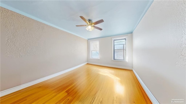 unfurnished room featuring hardwood / wood-style flooring and ceiling fan