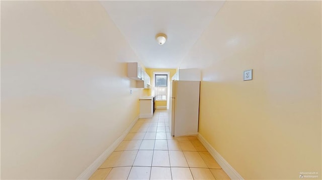 corridor with light tile patterned floors