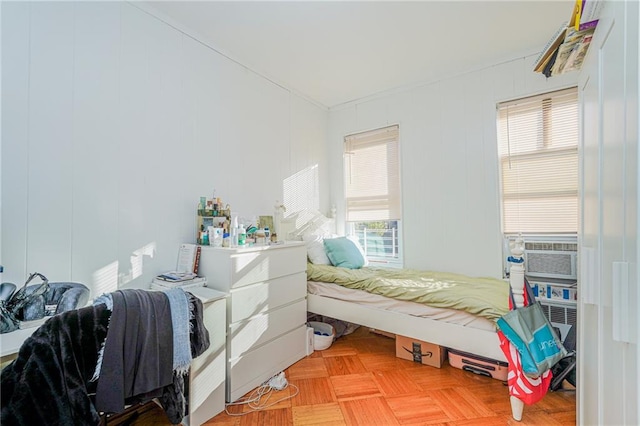 bedroom featuring parquet flooring and cooling unit