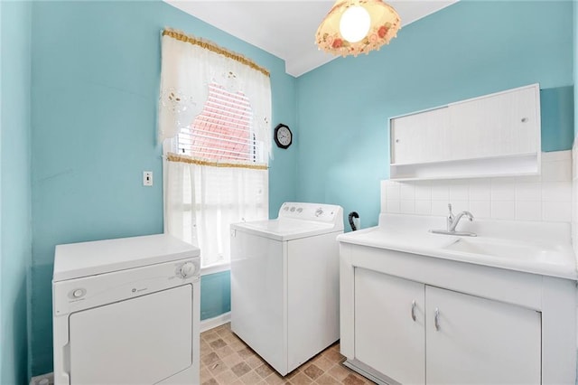 laundry area with washer and dryer and a sink