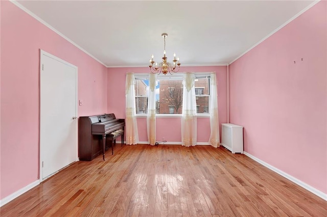 unfurnished dining area with light wood finished floors, a chandelier, radiator heating unit, and crown molding