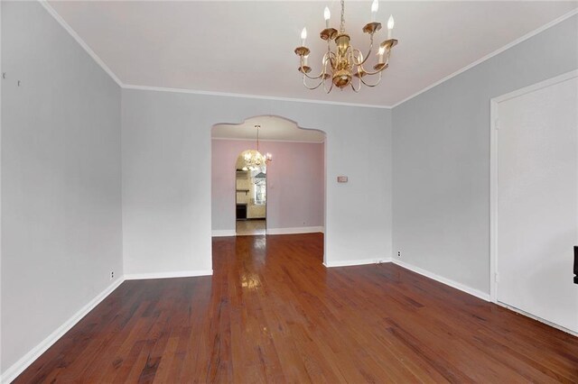 unfurnished dining area with ornamental molding, dark hardwood / wood-style floors, and a chandelier