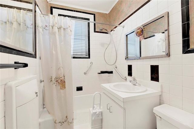 bathroom featuring crown molding, toilet, shower / bath combination with curtain, tile walls, and vanity