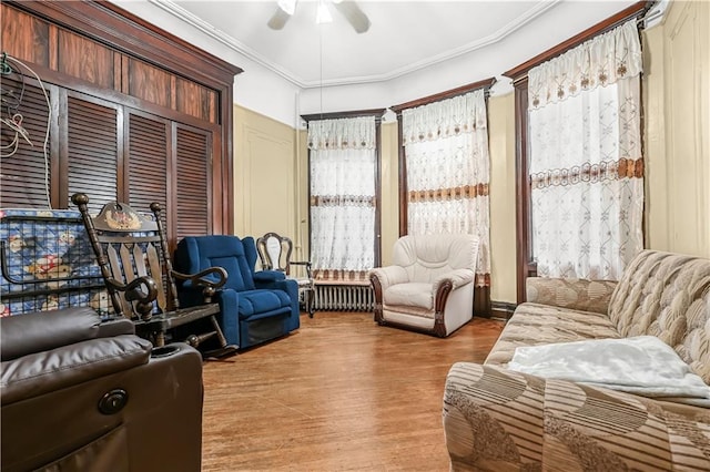 515 E 24th St, Brooklyn, NY 11210 - living area featuring radiator heating unit, ceiling fan, light wood-style floors, and crown molding