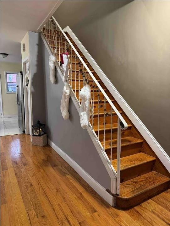 stairway with hardwood / wood-style floors