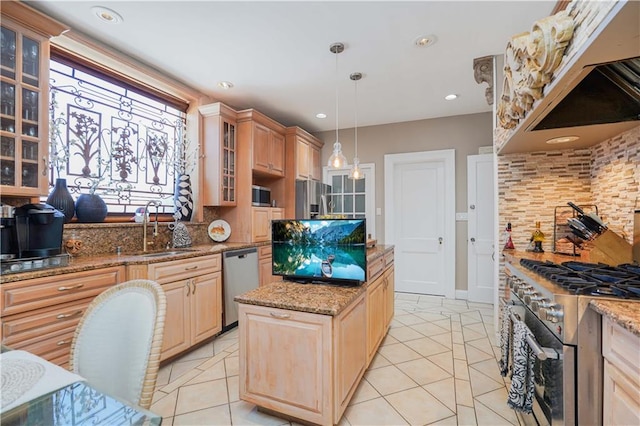 kitchen with a center island, light brown cabinetry, light tile patterned flooring, stainless steel appliances, and a sink