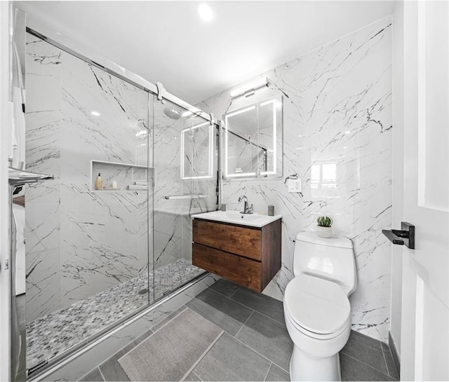 bathroom featuring vanity, an enclosed shower, and toilet