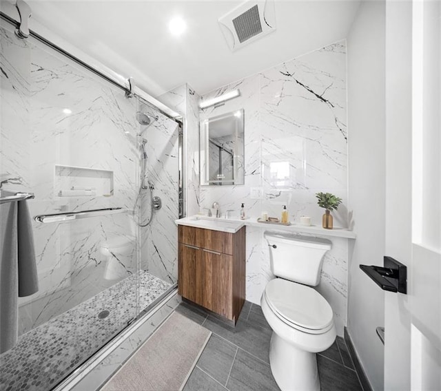 bathroom featuring vanity, a shower with door, tile walls, and toilet