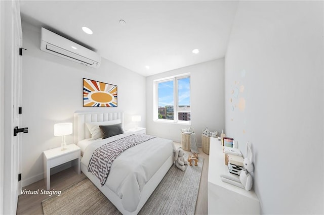 bedroom featuring hardwood / wood-style floors and an AC wall unit