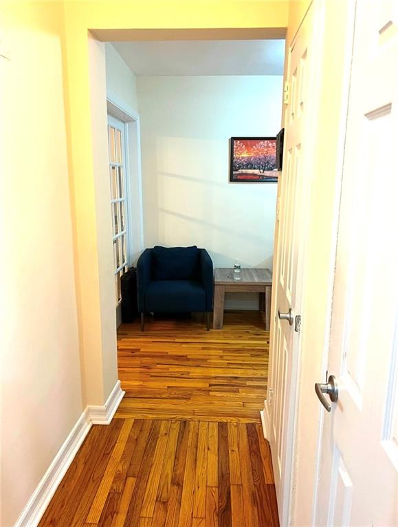 hall with hardwood / wood-style floors