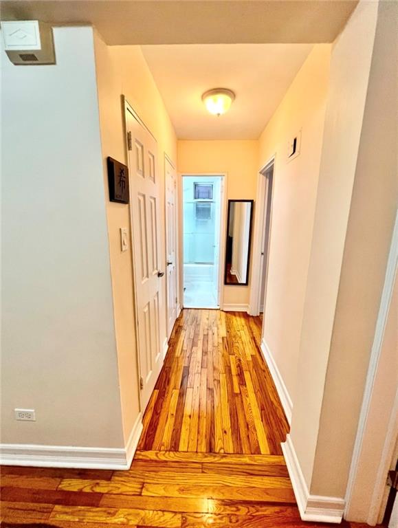 corridor with light hardwood / wood-style floors