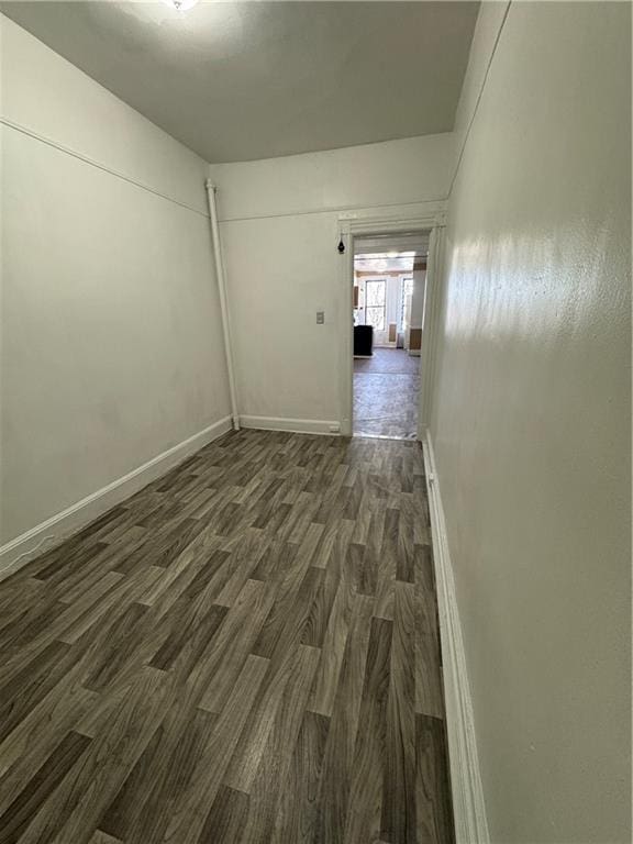 spare room featuring dark wood-type flooring