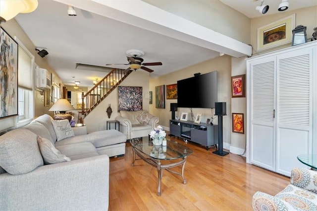 living room with light hardwood / wood-style flooring and ceiling fan