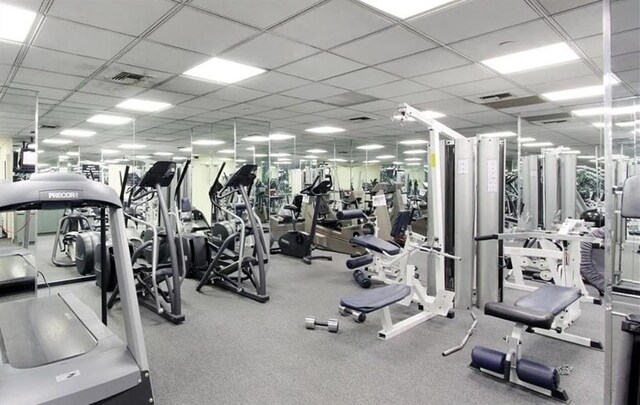 workout area with a paneled ceiling