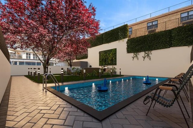 view of swimming pool featuring a patio