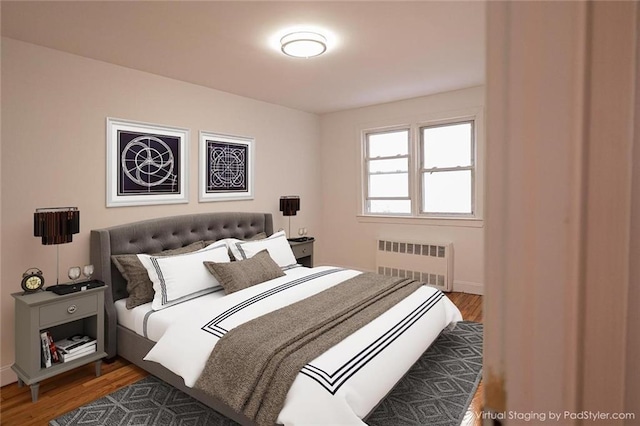 bedroom featuring radiator heating unit and dark hardwood / wood-style flooring