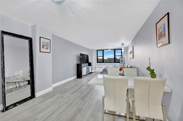 dining area featuring radiator and light hardwood / wood-style floors