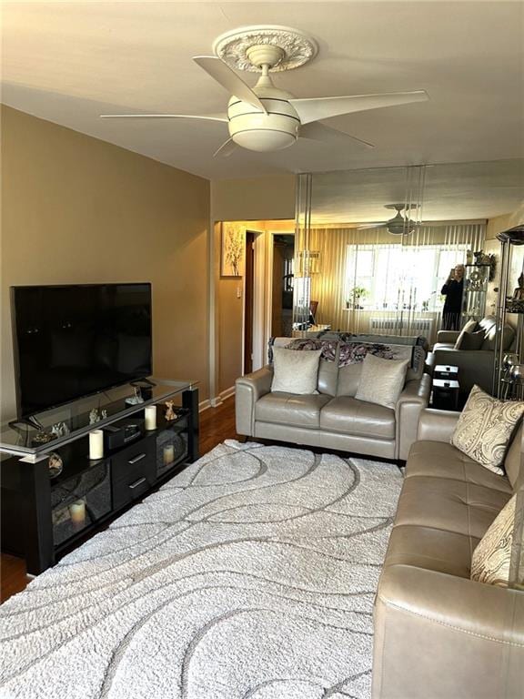 living room with hardwood / wood-style flooring, vaulted ceiling, and ceiling fan