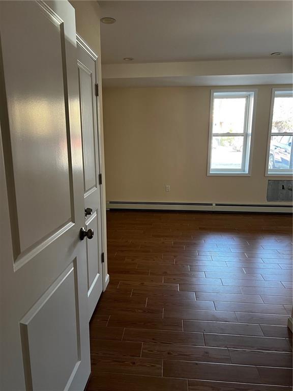 spare room with dark hardwood / wood-style floors