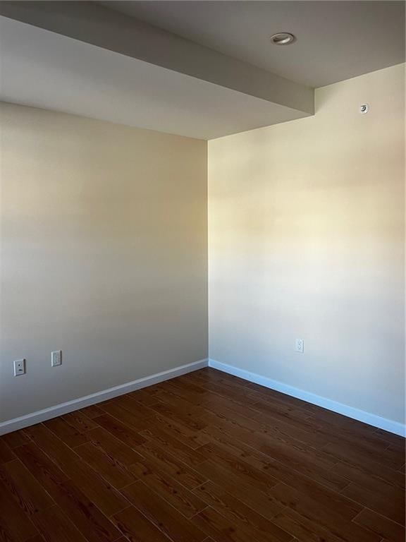 empty room with dark hardwood / wood-style floors