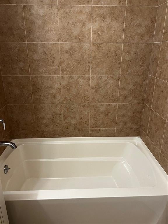 bathroom featuring a tub to relax in