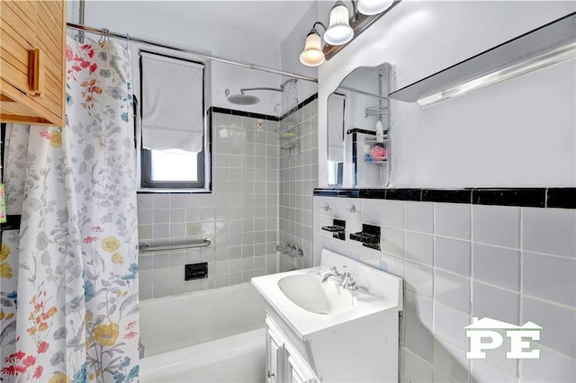 bathroom featuring vanity, tile walls, and shower / tub combo with curtain