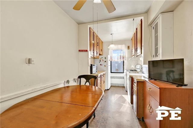 dining room featuring radiator and ceiling fan