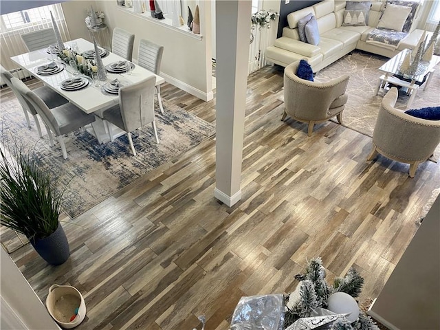 dining space featuring baseboards and wood finished floors