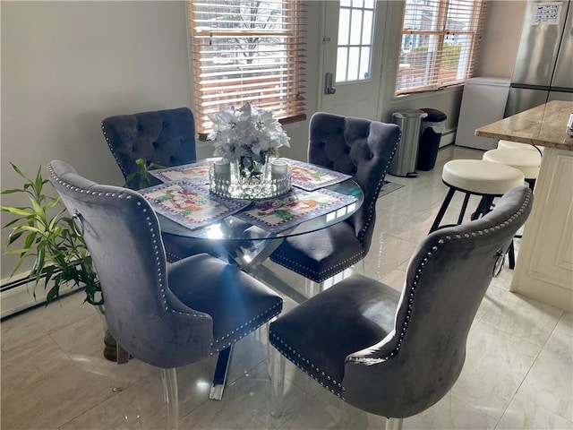 dining space with a baseboard heating unit