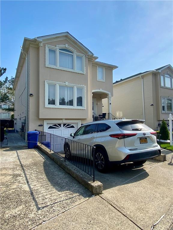 43 Lerer Ln, Staten Island, NY 10307 - view of front of property featuring driveway and stucco siding