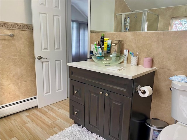 full bathroom with tile walls, a shower stall, toilet, and vanity