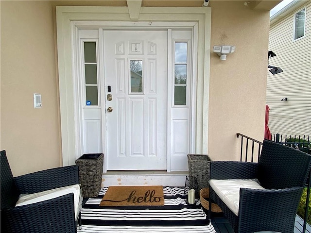 property entrance with stucco siding