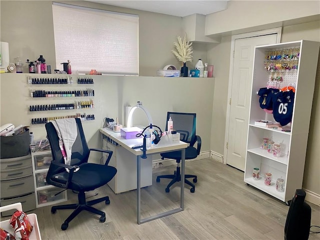 office area with baseboards and wood finished floors