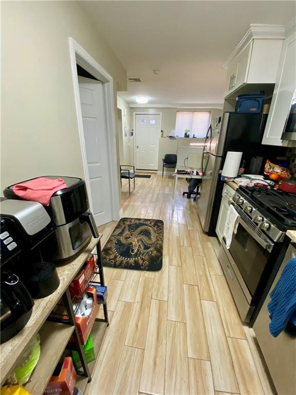 43 Lerer Ln, Staten Island, NY 10307 - kitchen featuring gas range, light wood-style floors, and white cabinets