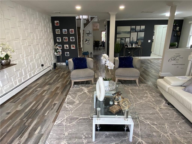 living area with baseboards, decorative columns, wood finished floors, and crown molding