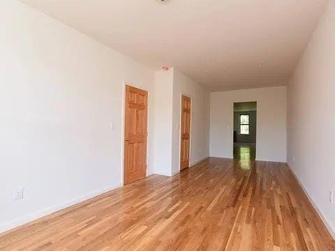 unfurnished room with light wood-type flooring