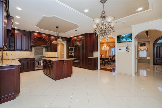 kitchen with an inviting chandelier, light tile patterned floors, arched walkways, tasteful backsplash, and appliances with stainless steel finishes