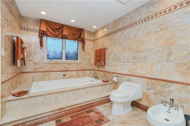 bathroom featuring a bidet, marble finish floor, toilet, a bath, and tile walls