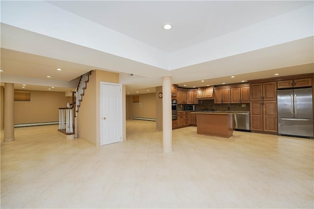 kitchen featuring stainless steel appliances, baseboard heating, recessed lighting, and a kitchen island