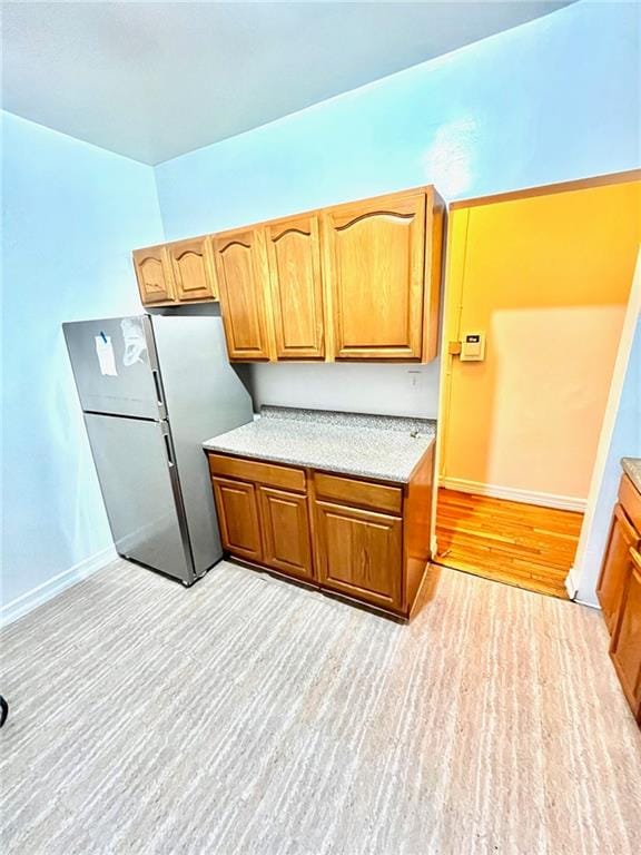 kitchen featuring stainless steel fridge and light wood-type flooring