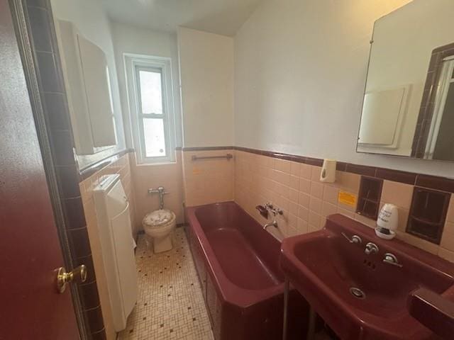 860 Grand Concourse Unit 4I, Bronx, NY 10451 - full bathroom with tile walls, a garden tub, toilet, a sink, and a wainscoted wall
