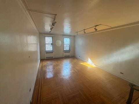 860 Grand Concourse Unit 4I, Bronx, NY 10451 - empty room featuring track lighting, baseboards, attic access, and crown molding