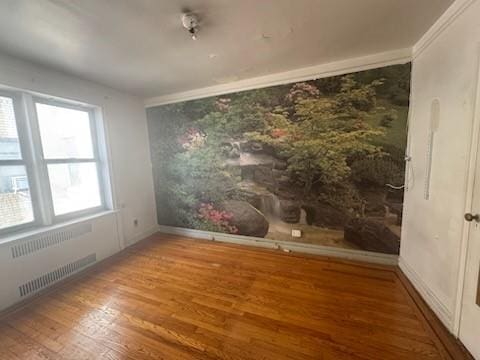860 Grand Concourse Unit 4I, Bronx, NY 10451 - spare room featuring radiator, wood finished floors, and baseboards