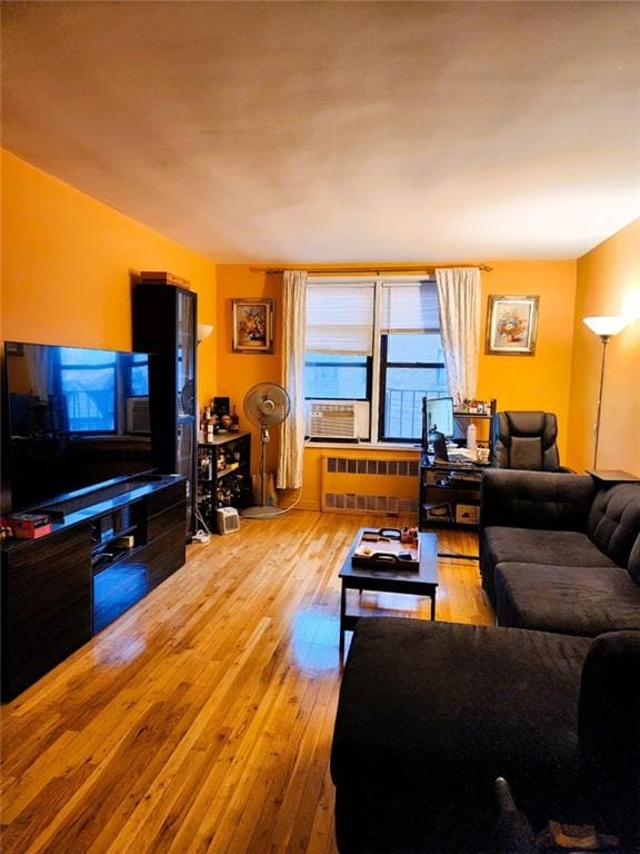 living room featuring radiator and light hardwood / wood-style flooring