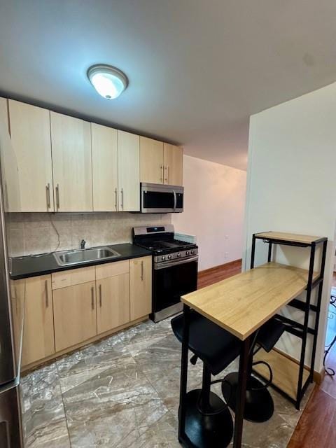 448 Neptune Ave Unit 19M, Brooklyn, NY 11224 - kitchen featuring stainless steel appliances, light brown cabinets, dark countertops, and decorative backsplash