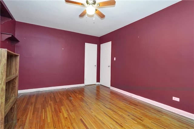 empty room featuring wood-type flooring and ceiling fan