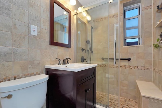 bathroom with tile walls, decorative backsplash, vanity, walk in shower, and toilet